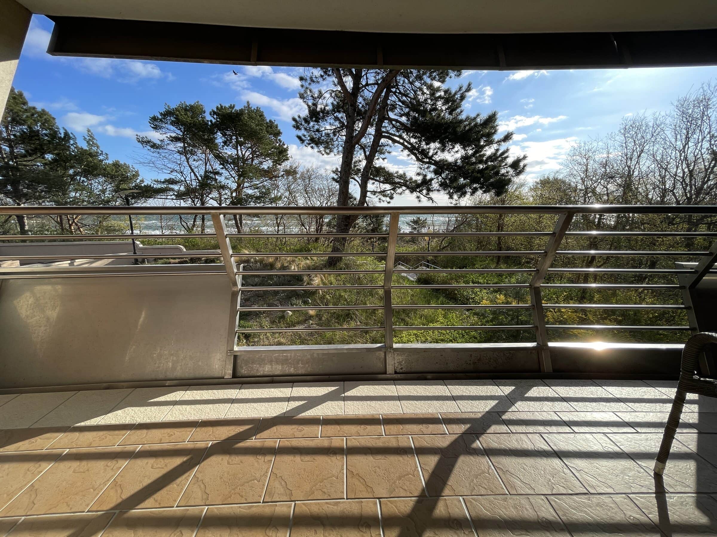 Balcony of Apartament Zdrojowy 323 overlooking pine trees and the open Baltic Sea