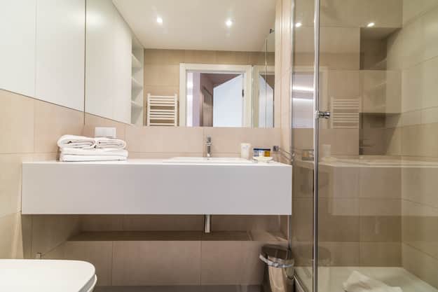 Bathroom in Apartament Zdrojowy 323 - vanity with a wooden countertop and glazed walk-in shower
